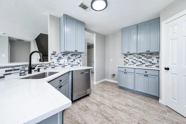 a kitchen with sink cabinets and window