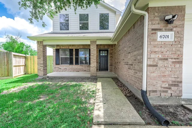 a view of a brick house with a large window