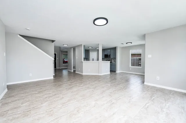 a view of a kitchen with a sink and a refrigerator