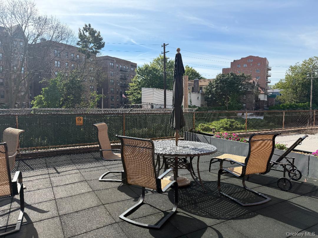 83-40 Austin Street, Unit 4L Queens, NY 11415 - Photo 4 of 12 View of patio featuring outdoor dining area