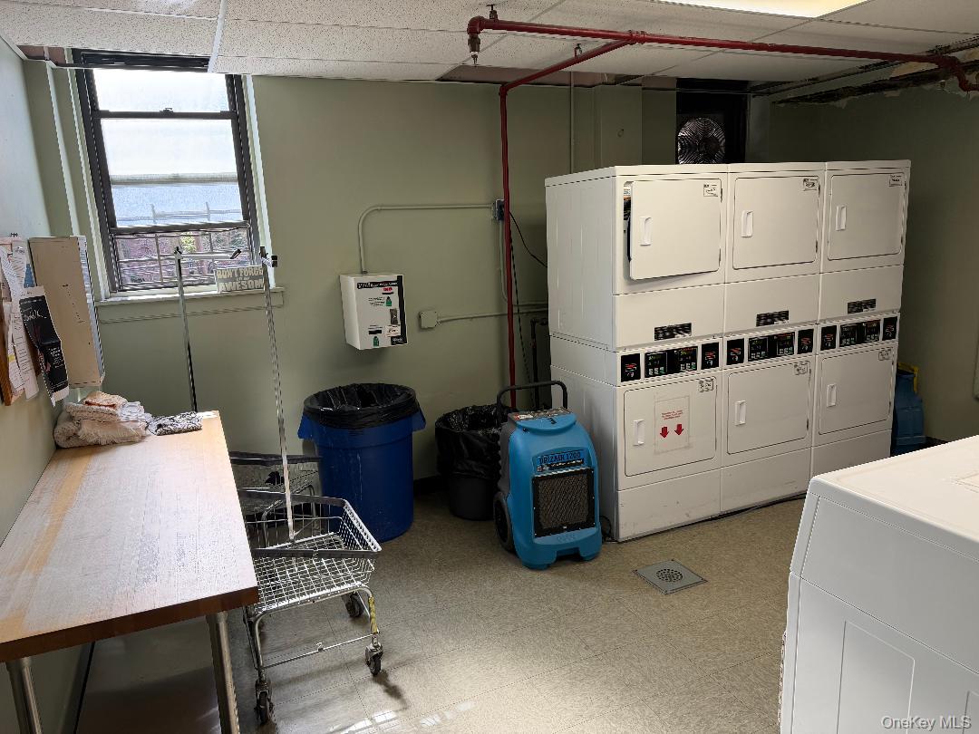 83-40 Austin Street, Unit 4L Queens, NY 11415 - Photo 6 of 12 Communal laundry room featuring stacked washer / dryer and a paneled ceiling