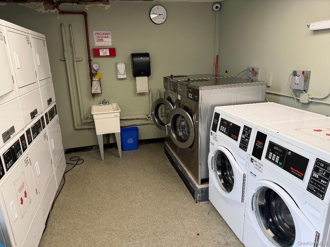 83-40 Austin Street, Unit 4L Queens, NY 11415 - Photo 7 of 12 Community laundry room with stacked washer / drying machine and washing machine and clothes dryer