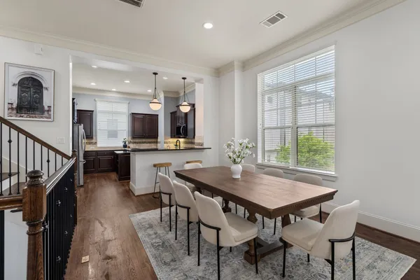 a view of a dining room with furniture and wooden floor