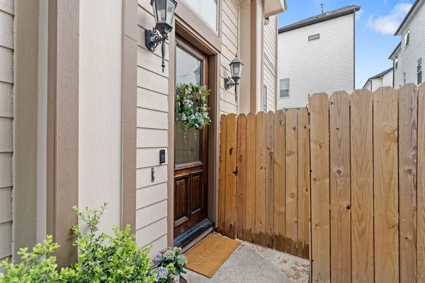 a front view of a house with iron fence