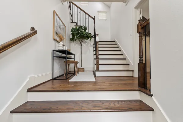 a view of entryway and hall with wooden floor