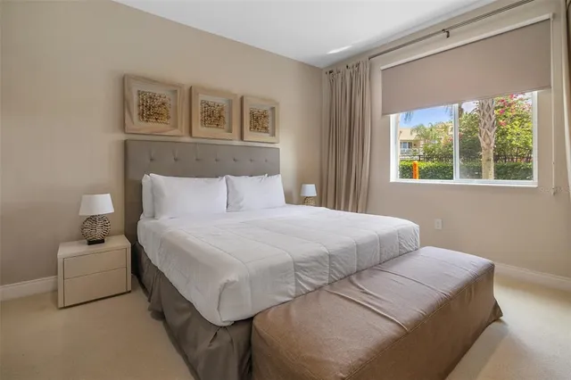 a bedroom with a bed and a large window