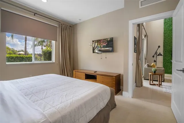 a bedroom with a bed and a tv on table