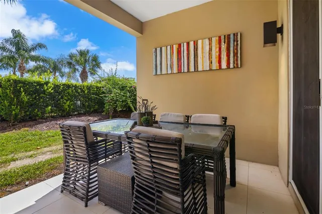 a view of a patio with a table and chairs