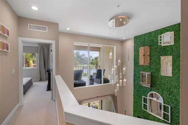 a view of a livingroom with furniture wooden floor and windows