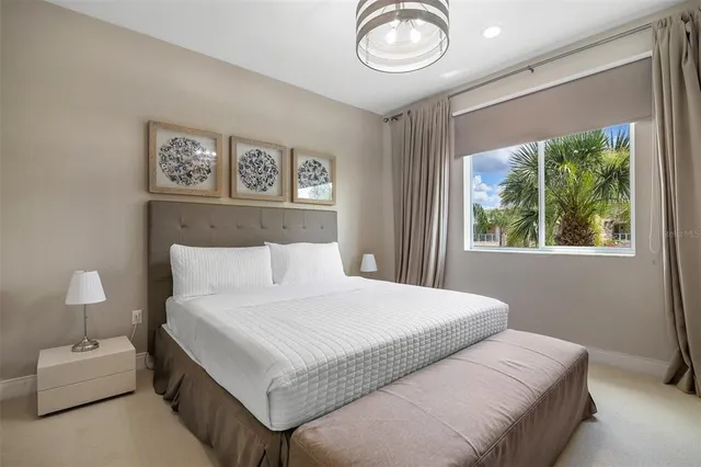 a bedroom with a bed and a painting on the wall