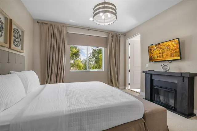 a bedroom with a bed and a flat screen tv