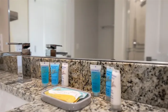 a bathroom with a sink a mirror and a shower