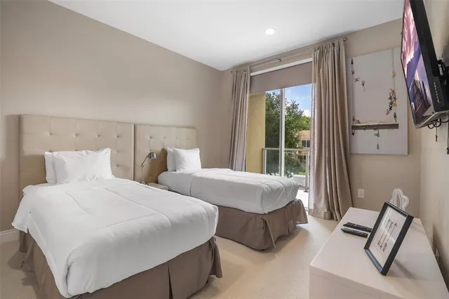 a bedroom with two beds and a large window