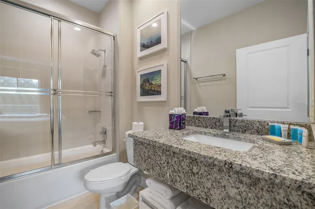 a bedroom with bed and glass door