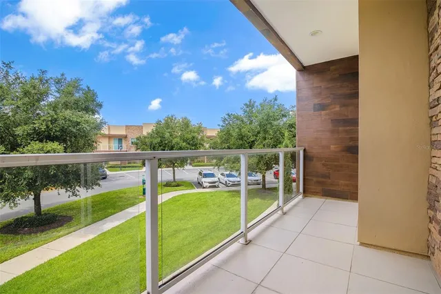 a kitchen with kitchen island a dining table chairs stainless steel appliances and cabinets
