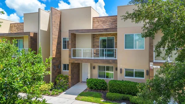 an aerial view of residential houses with yard