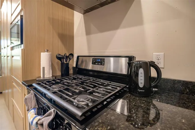 a stove top oven sitting inside of a kitchen