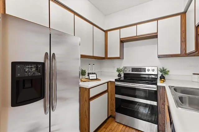 a kitchen with stainless steel appliances and cabinets