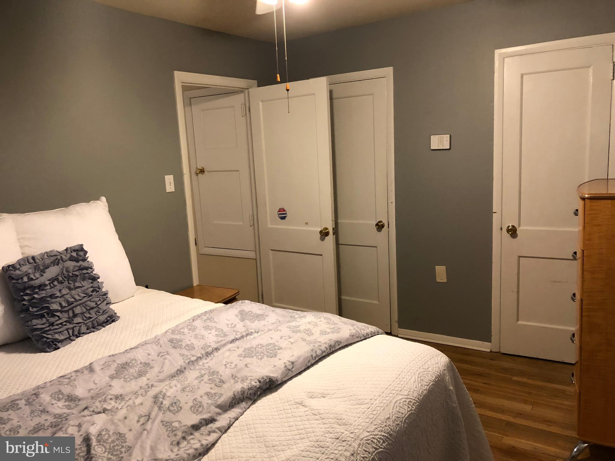 725 Four Mile Road Alexandria, VA 22305 - Photo 13 of 23 a bedroom with a bed and a walk in closet