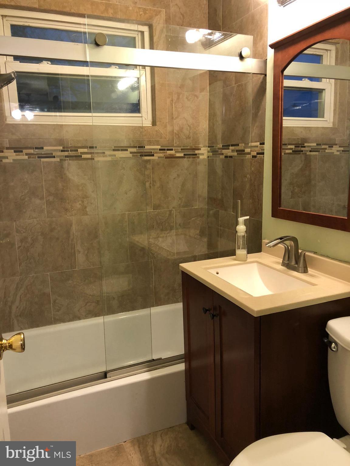 725 Four Mile Road Alexandria, VA 22305 - Photo 17 of 23 a bathroom with a sink and a mirror