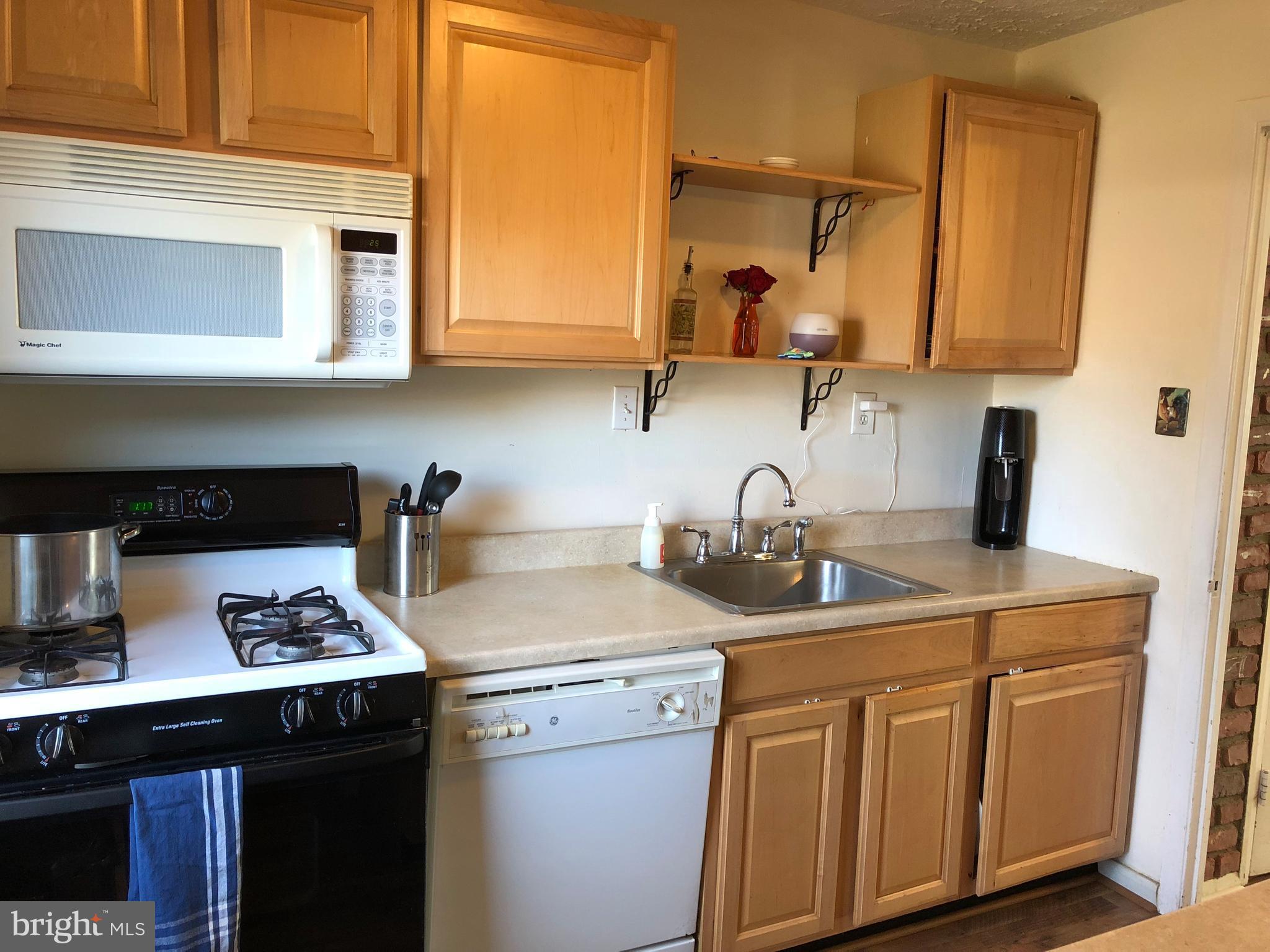 725 Four Mile Road Alexandria, VA 22305 - Photo 8 of 23 a kitchen with stainless steel appliances granite countertop a sink stove and cabinets