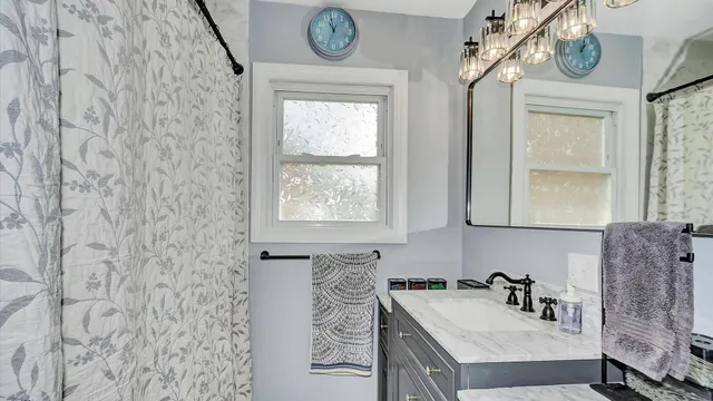 a bathroom with a sink a vanity and a mirror