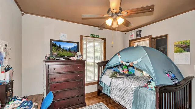 a bedroom with a bed and a chandelier