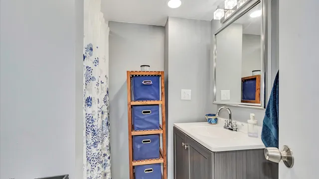 a bathroom with a sink mirror and a shower