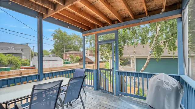 a view of a porch with furniture and wooden deck