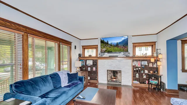 a living room with furniture large window and a fireplace