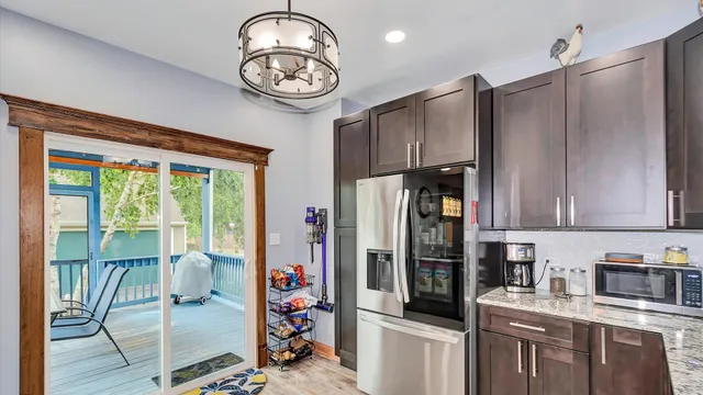 a kitchen with stainless steel appliances granite countertop a refrigerator and a stove top oven