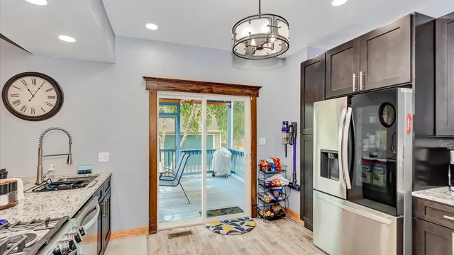a kitchen with stainless steel appliances granite countertop a stove and a refrigerator