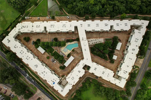 an aerial view of a residential houses with city view