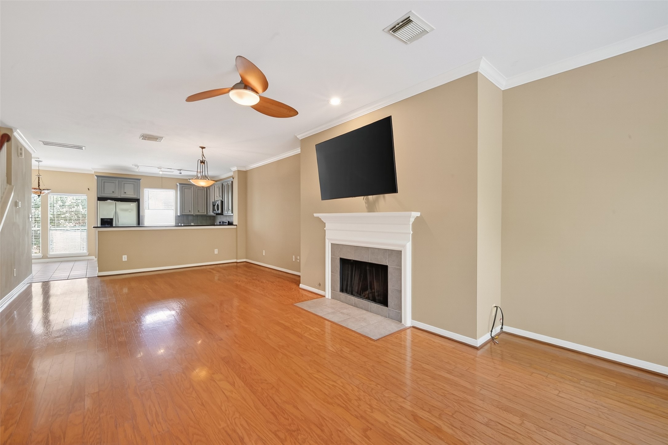 2804 Chenevert Street Houston, TX 77004 - Photo 20 of 37 a view of a livingroom with a fireplace a ceiling fan and wooden floor