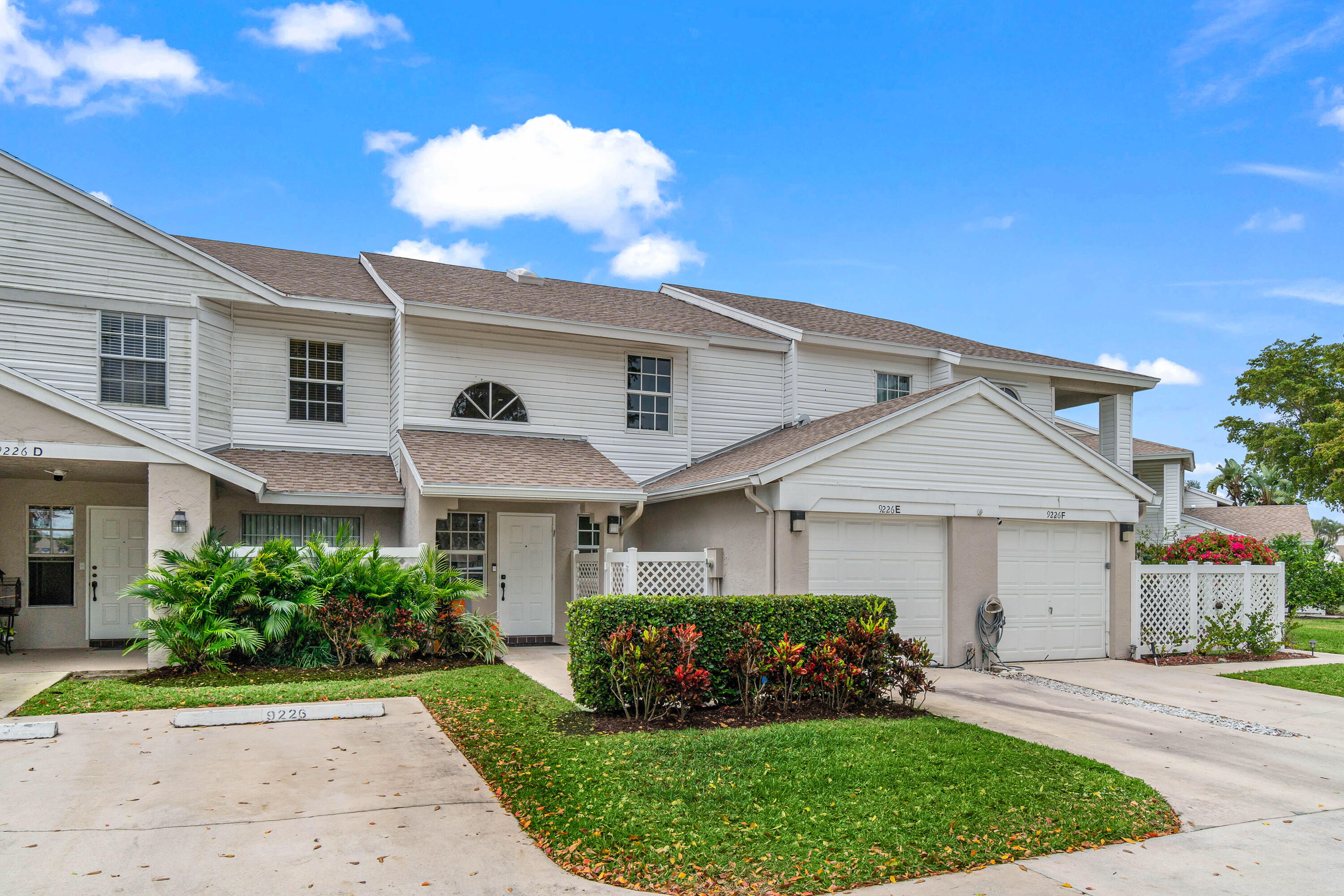 9226 Boca Gardens Parkway, Unit E Boca Raton, FL 33496 - Photo 1 of 40 a front view of a house with a garden