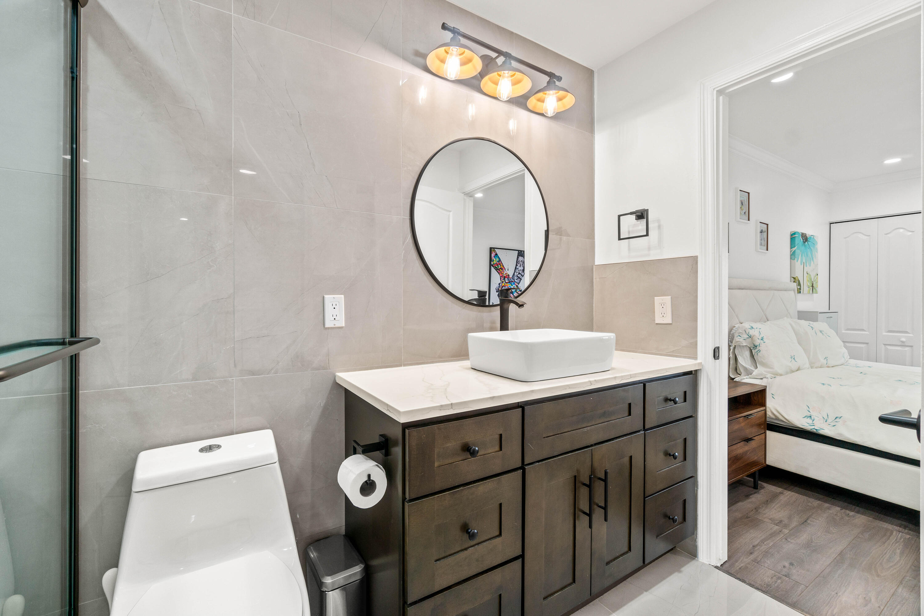 9226 Boca Gardens Parkway, Unit E Boca Raton, FL 33496 - Photo 27 of 40 a bathroom with a toilet a sink and a mirror
