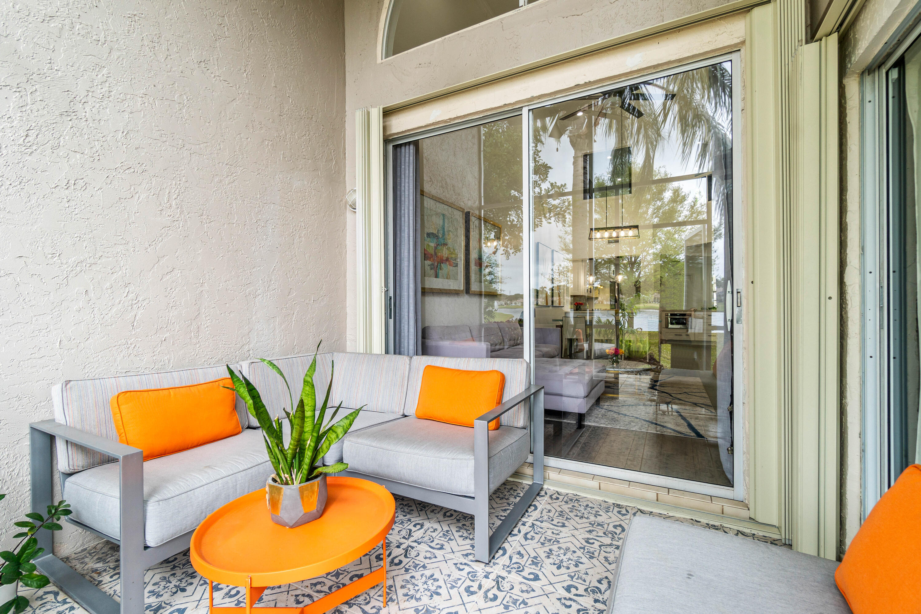 9226 Boca Gardens Parkway, Unit E Boca Raton, FL 33496 - Photo 33 of 40 a living room with furniture potted plant and a painting on the wall