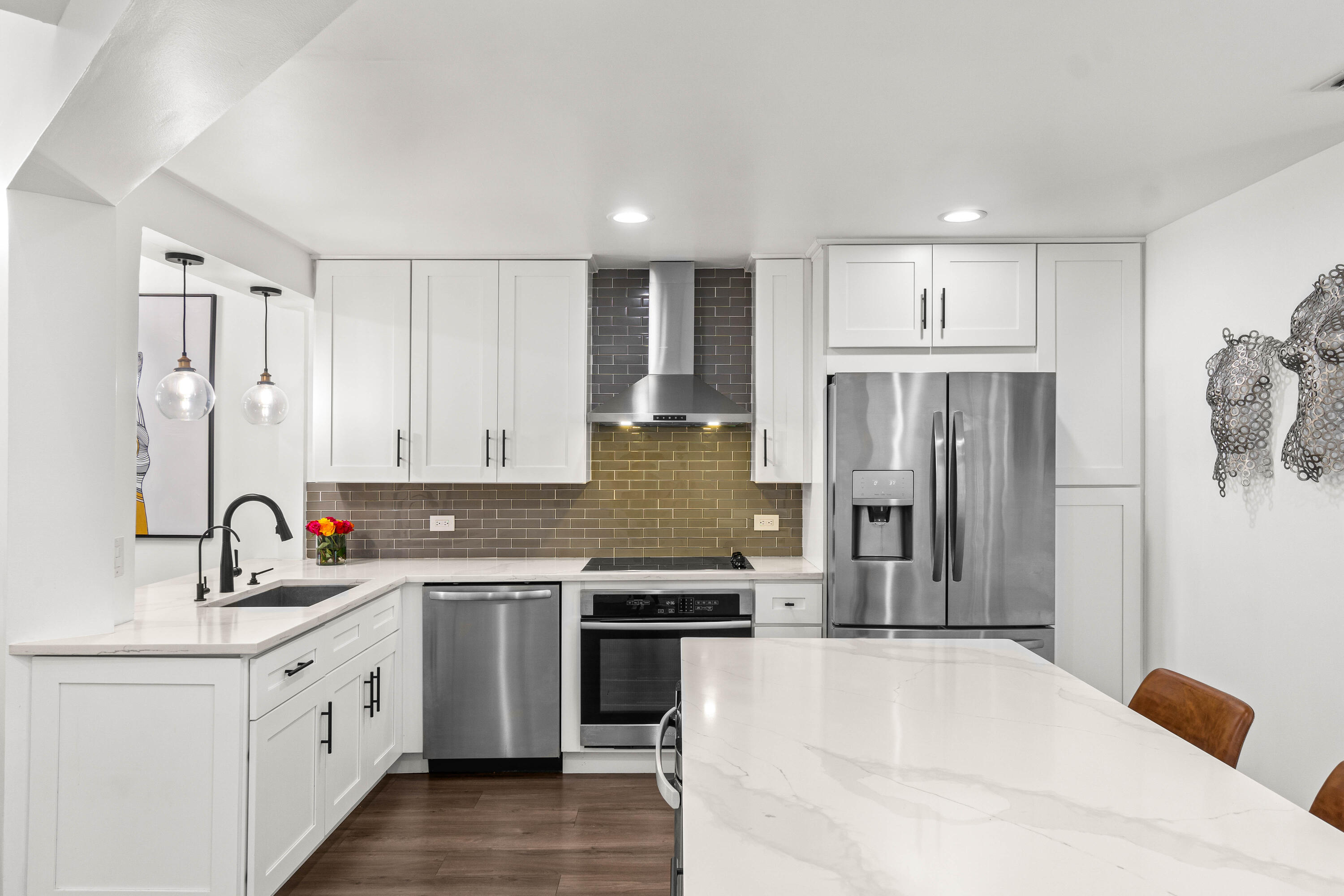 9226 Boca Gardens Parkway, Unit E Boca Raton, FL 33496 - Photo 8 of 40 a kitchen with white cabinets and stainless steel appliances