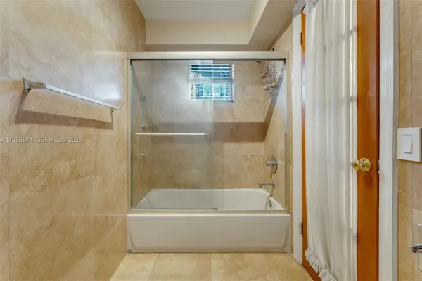 a bathroom with a bathtub and a shower