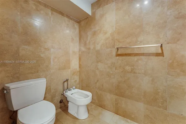 a white toilet sitting next to a shower curtain