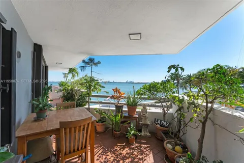 a view of a porch with furniture and a potted plant