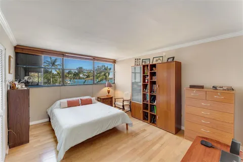 a bedroom with a bed and a bookshelf