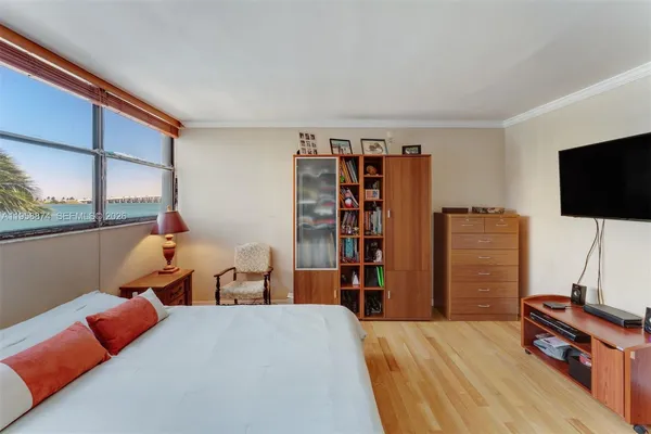 a bedroom with furniture and a flat screen tv