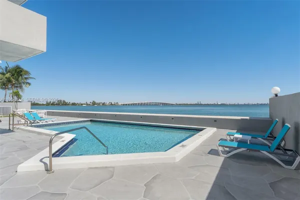 a view of swimming pool with lounge chair