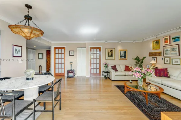 a living room with dining room and wooden floor