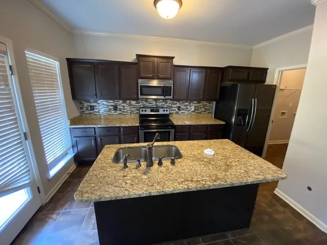 a kitchen with a sink and refrigerator