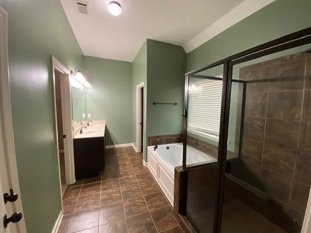 a bathroom with a double vanity sink and mirror
