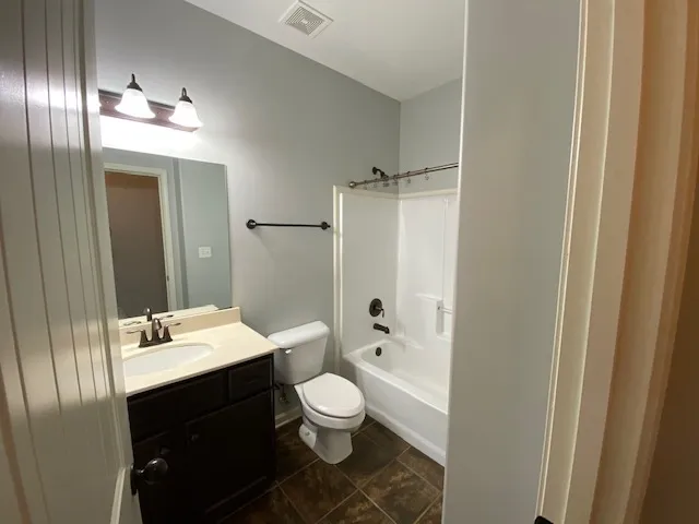 a bathroom with a double vanity sink toilet mirror and shower