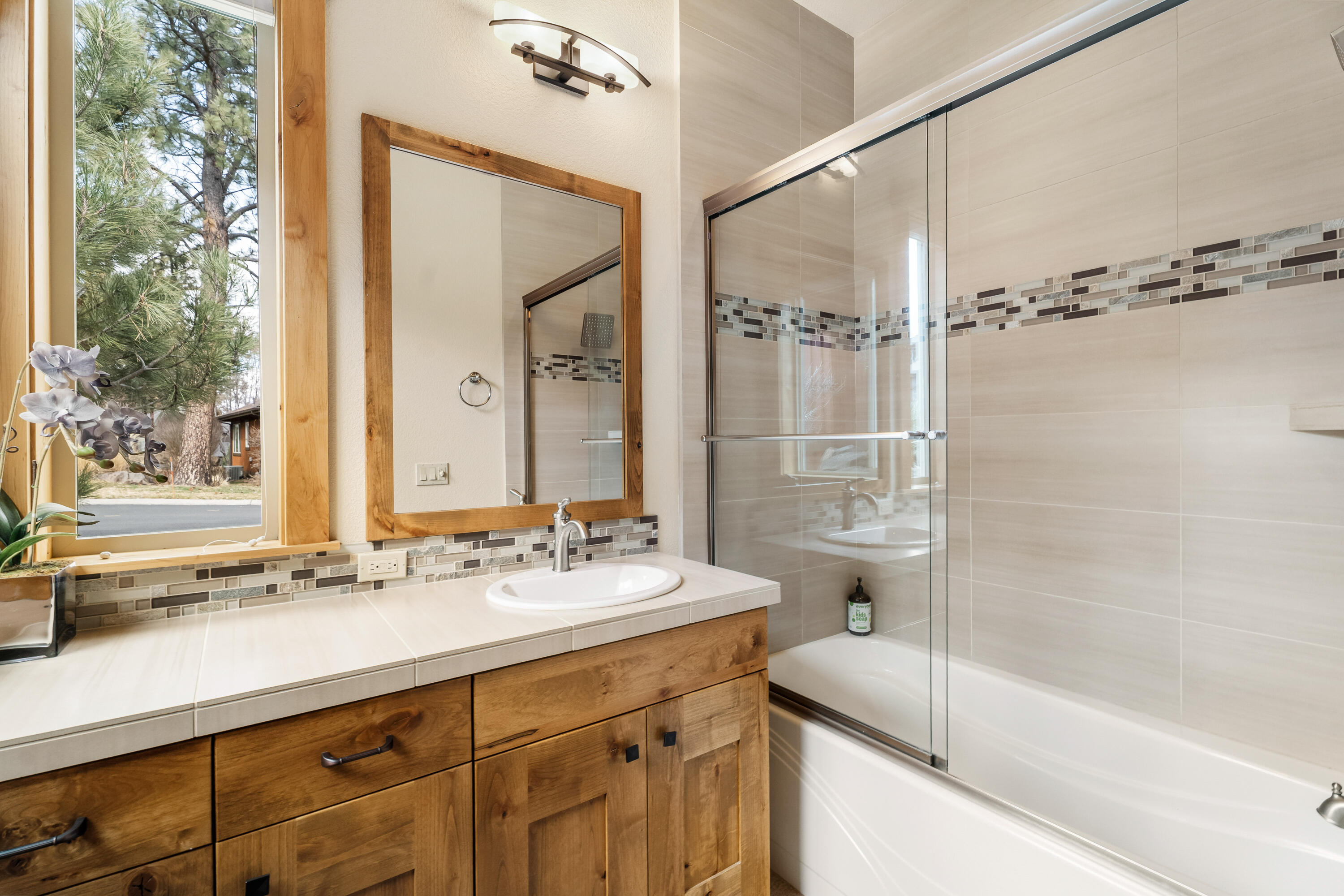 18667 Coffee Court Bend, OR 97702 - Photo 11 of 30 a bathroom with a double vanity sink and mirror with bathtub