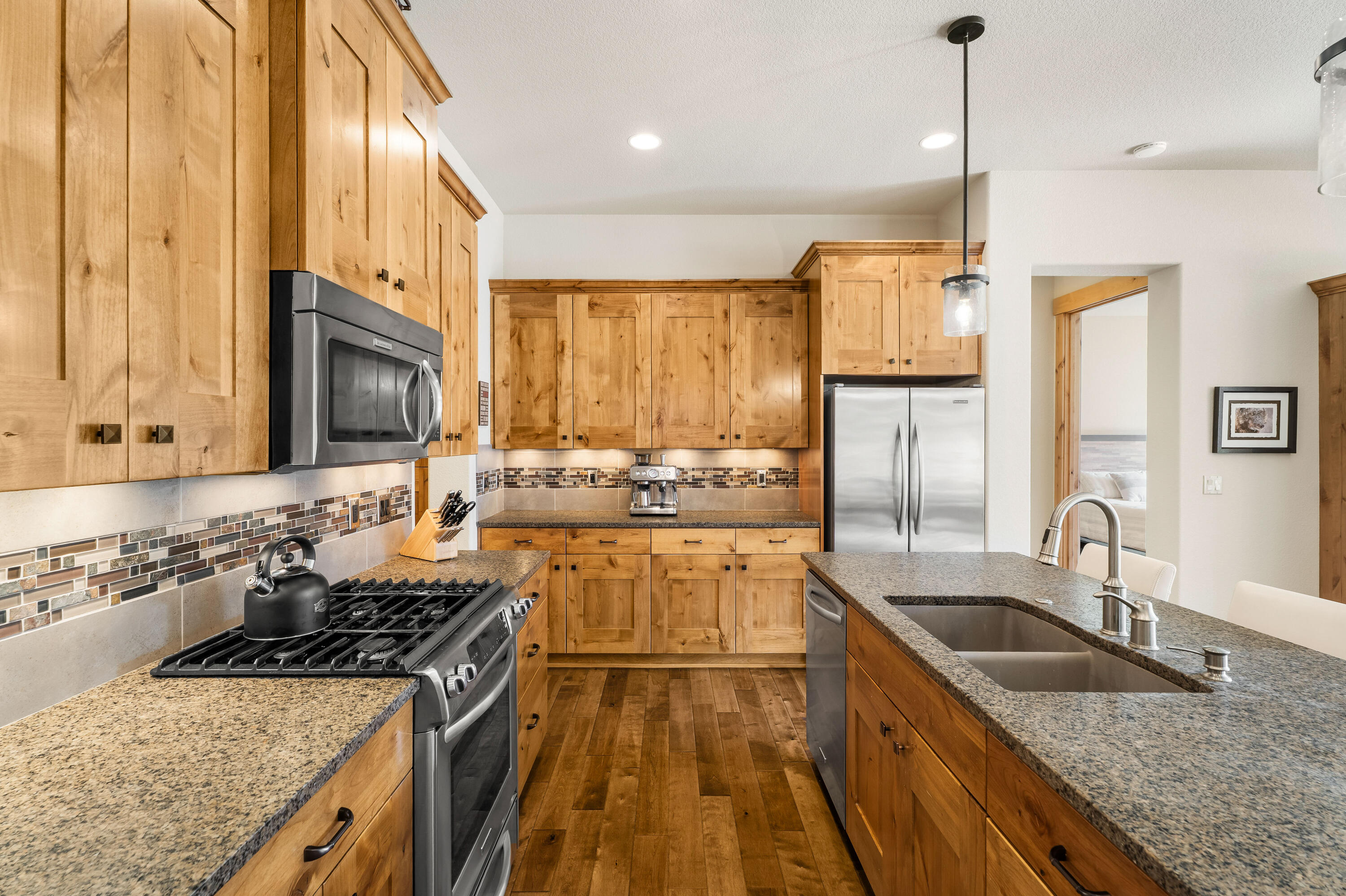 18667 Coffee Court Bend, OR 97702 - Photo 14 of 30 a kitchen with stainless steel appliances granite countertop a sink stove and refrigerator